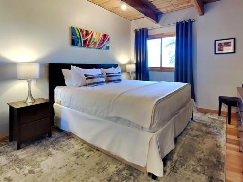a bedroom with a large white bed with blue curtains at Timberline Condominiums 1 Bedroom Deluxe Unit B1C in Snowmass Village