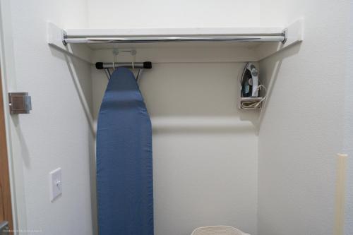 a blue tie is hanging in a closet at Texas Bungalows Hotel and Hotel Que at i35 Austin Pflugerville in Pflugerville