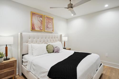a white bedroom with a large white bed with white pillows at The Eleanor New Orleans in New Orleans