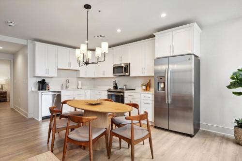 a kitchen with a table and chairs and a refrigerator at The Eleanor New Orleans in New Orleans