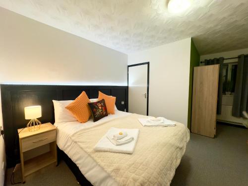 a bedroom with a large bed with two plates on it at Coastal Park Accommodation in Llanelli