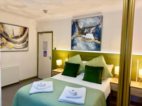 a hotel room with two beds with towels on them at Coastal Park Accommodation in Llanelli
