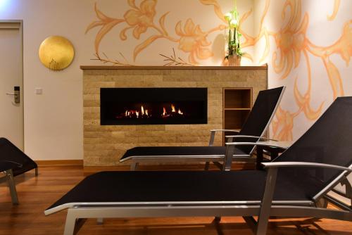 a living room with chairs and a fireplace at Hotel Alte Vogtei in Wolframs-Eschenbach