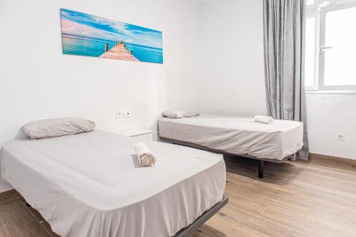 Ένα ή περισσότερα κρεβάτια σε δωμάτιο στο Apartamento a 3 min playa Canteras