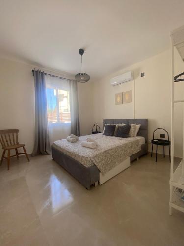 a bedroom with a bed and a large window at Mari House-close to the beach in Paphos