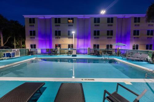 a pool in front of a hotel at night at Sleep Inn Ormond Beach - Daytona in Ormond Beach