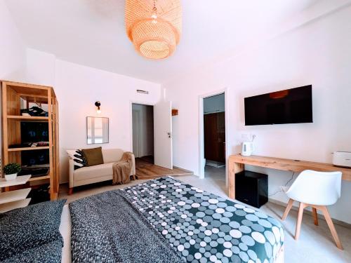 a white bedroom with a bed and a desk at CHERRY BLOSSOM Apartments in Legnano