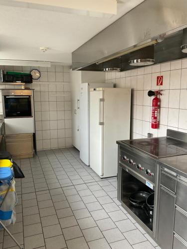 a kitchen with a refrigerator and a stove at 19 - Gästehaus Erika - Hundwil - Appenzellerland in Hundwil