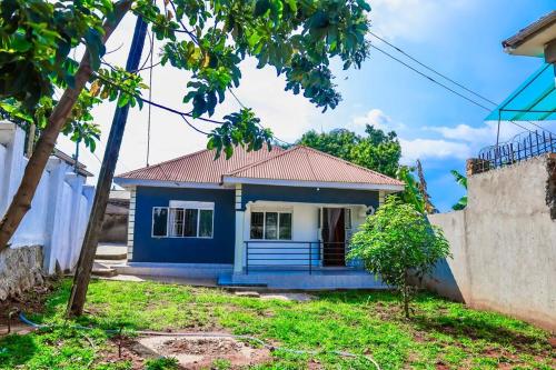 a blue house with a red roof at Nappers Secrets in Kampala
