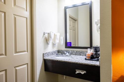 a bathroom with a sink and a mirror at Sleep Inn Ormond Beach - Daytona in Ormond Beach