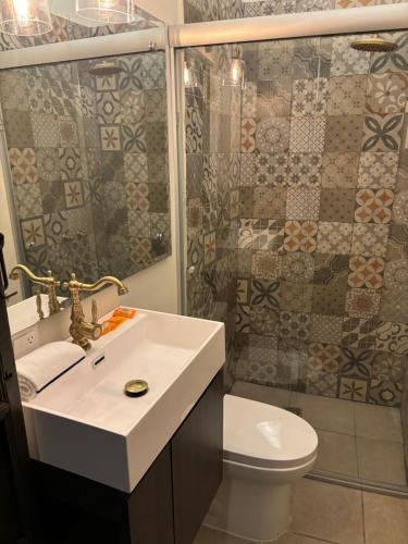 a bathroom with a sink and a toilet and a shower at Hotel Boutique Casona los Pavorreales in Durango