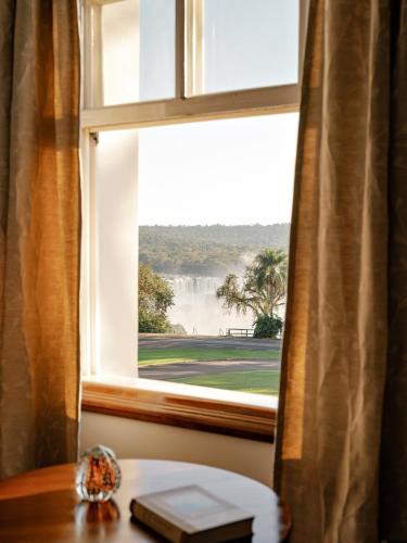 a window with a view of a waterfall at Hotel das Cataratas, A Belmond Hotel, Iguassu Falls in Foz do Iguaçu