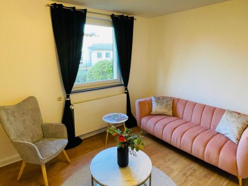 a living room with a couch and a chair at Kreativer Rückzugsort in der Burgenstadt Schlitz in Schlitz
