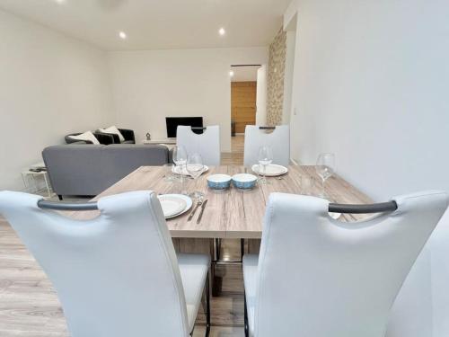 a dining room with a wooden table and chairs at T3 spacieux refait à neuf in Thyez