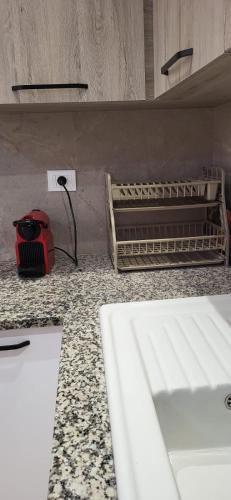 a kitchen counter with a red appliance on a counter top at Maison indépendante in Hammamet Nord