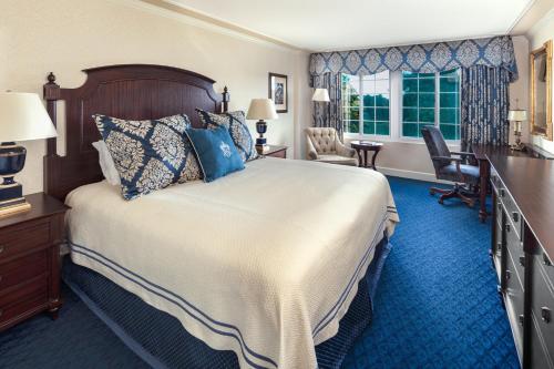 a hotel room with a bed and a desk at Washington Duke Inn & Golf Club in Durham