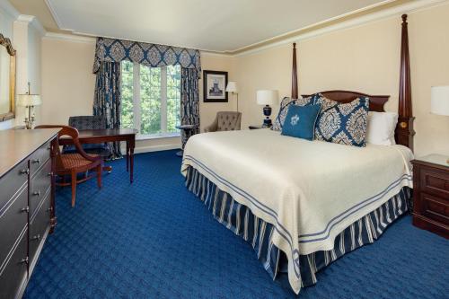 a hotel room with a large bed and a desk at Washington Duke Inn & Golf Club in Durham