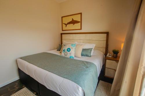 a bedroom with a bed with a fish picture on the wall at Hotel Villareal São Francisco do Sul in São Francisco do Sul