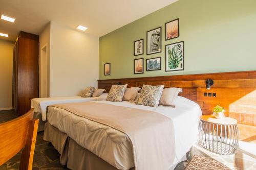 two beds in a hotel room with at Hotel Villareal São Francisco do Sul in São Francisco do Sul