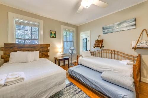 two beds in a room with two windows at Fire Pit, Large Yard Midtown Columbus Bungalow! in Columbus