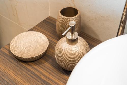 a bathroom with a toilet with two vases on it at Cicogna House in Villanova