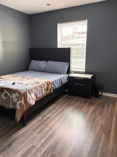 a bedroom with a bed and a window at Nwk 457 RM 213-F in Newark