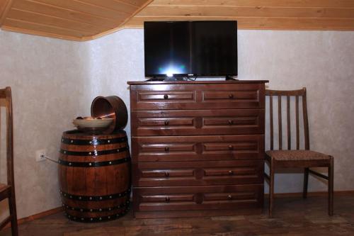 a television on top of a dresser with a chair at Duvaro Guesthouse in Raduil