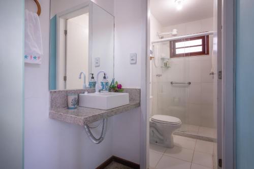 a bathroom with a sink and a toilet at Casa paradise perto da praia Guarajuba - BA in Camacari