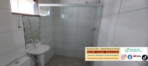 a white bathroom with a sink and a toilet at Arraial do Cabo – Subuai Village - Aluguel Econômico in Arraial do Cabo