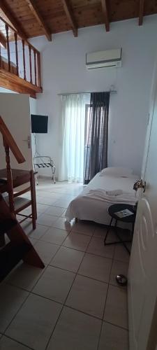a bedroom with a bed and a tiled floor at Apartments Barbie in Rethymno Town