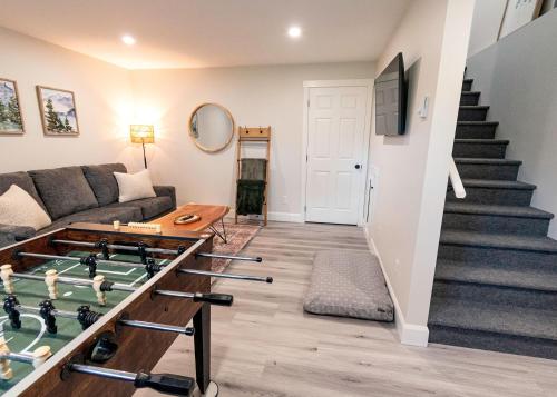 a living room with a couch and a stairway at Hillside Haven 1 Bedroom with Hot Tub in Sussex