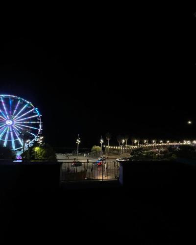 a ferris wheel in a park at night at Seafront View in Mola di Bari