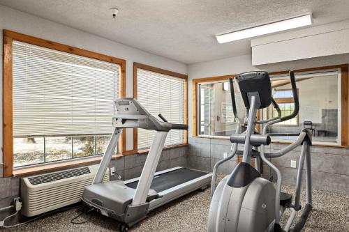 a fitness room with a treadmill and windows at Kelly Inn Billings in Billings
