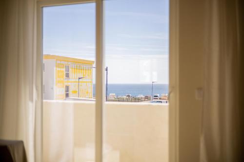 a view of the ocean from a hotel room window at Pontalaia Atlantic View in Sagres