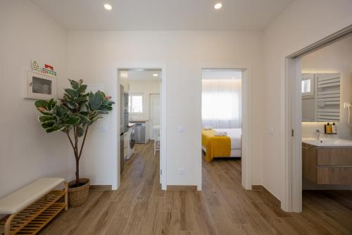 a white room with a sink and a bedroom at Pontalaia Atlantic View in Sagres