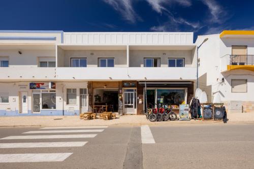 a white building with motorcycles parked in front of it at Pontalaia Atlantic View in Sagres