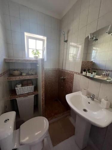 a bathroom with a toilet and a sink and a shower at Casa Oreo in Tarajalejo