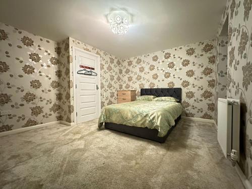 a bedroom with a bed and a white door at Best Places to Stay in Kent in Kent