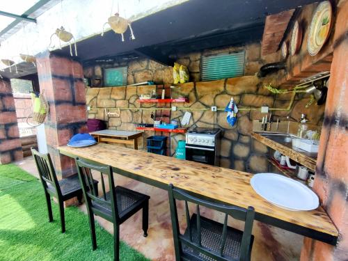 a kitchen with a long wooden table and chairs at Quarto águas- Casa Amazonia PT in Casconha