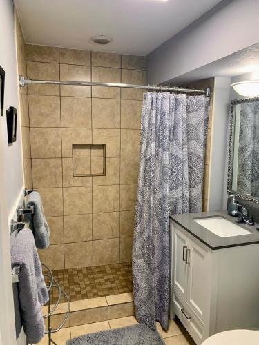 a bathroom with a shower and a sink at Cozy Bungalow in Winter Haven