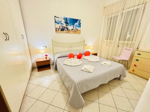 ein Schlafzimmer mit einem Bett mit roten Bällen darauf in der Unterkunft Viareggio on the Beach - Apartment in Viareggio