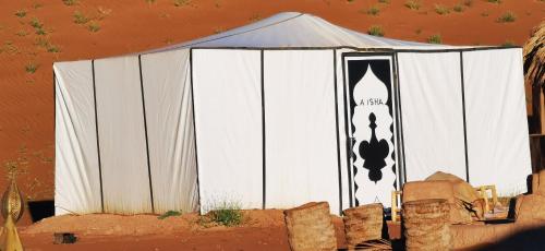a white tent with a black and white sign on it at Camp atlantic chegaga in Mhamid