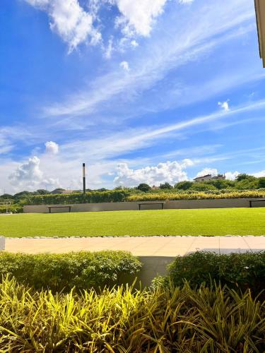 a view of a park with a field of grass at SMDC Green 2 Staycation, The Traditional & Modern Fusion Condo in Pasong Bayog