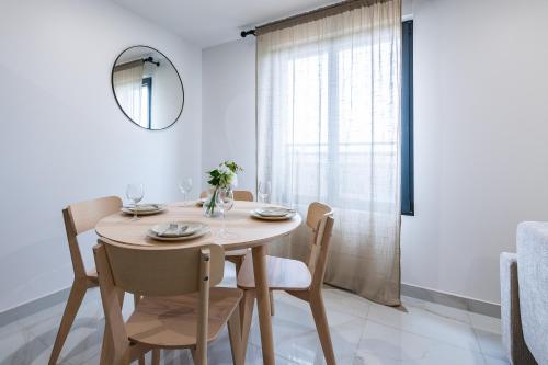 Un comedor con una mesa y sillas y un espejo. en Lovely appartement proche Disney, en Vaires-sur-Marne