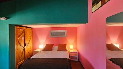 a bedroom with a bed with a colorful wall at Los Ancares Resort in Mina Clavero