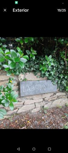 a sign for a garden with green plants at Catherine's Place by the sea in Dungarvan