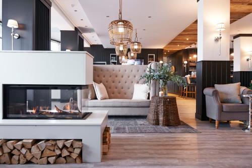 a living room with a fireplace and a couch at West Bay in Westende