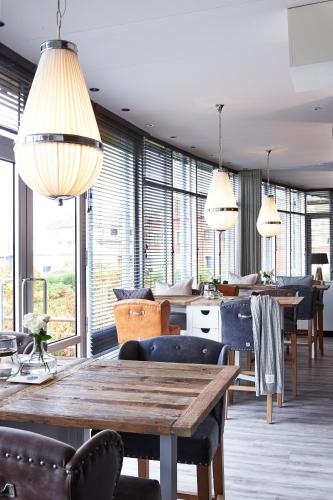 a dining room with a wooden table and chairs at West Bay in Middelkerke