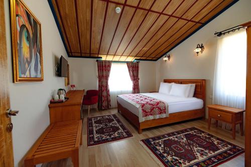 a bedroom with a bed and a wooden ceiling at Cappadocia Villa Comfort in Nevsehir