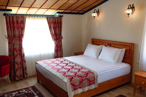 a bedroom with a bed and a window at Cappadocia Villa Comfort in Nevsehir